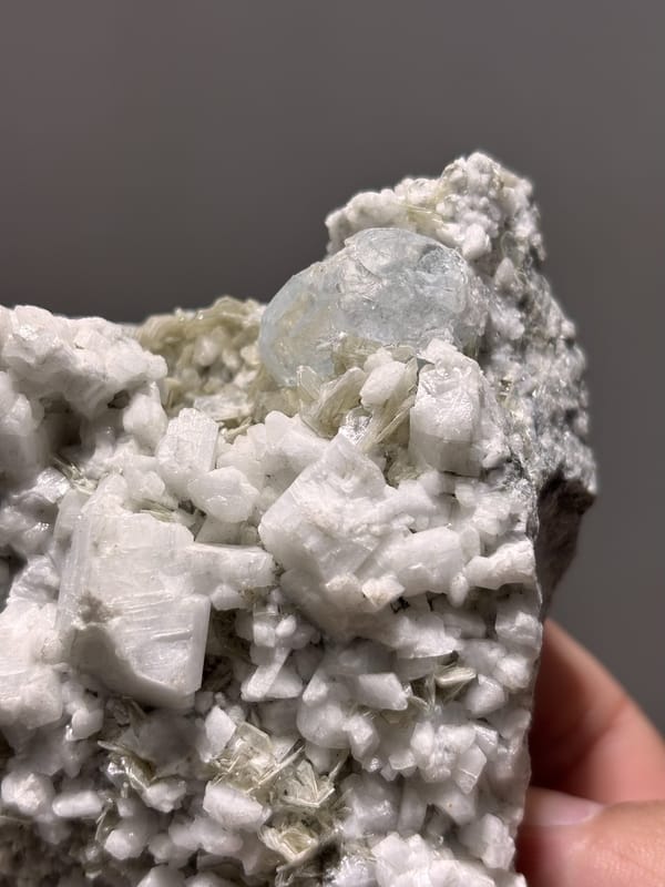 White feldspar plate with pale aquamarine crystals from Xuebaoding, Sichuan, China, close-up of the crystal faces