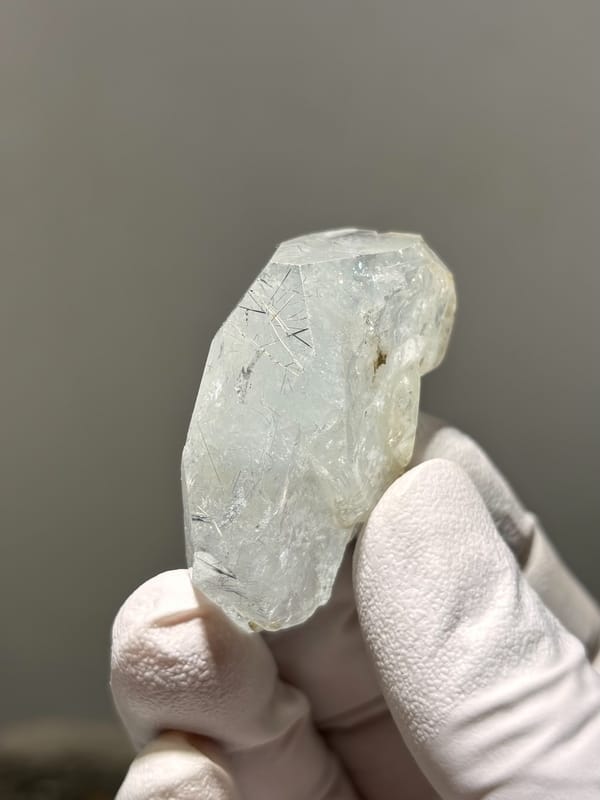 Clear aquamarine tablet with jamesonite needles inside from Xuebaoding, Sichuan, China, second angle
