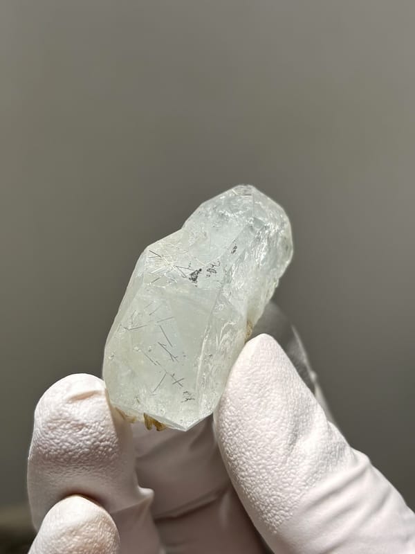 Clear aquamarine tablet with jamesonite needles inside from Xuebaoding, Sichuan, China, reverse side