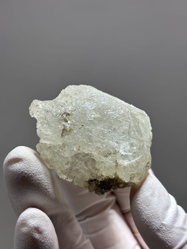 Etched aquamarine with mica and feldspar from Sichuan, China, close-up of the crystal faces