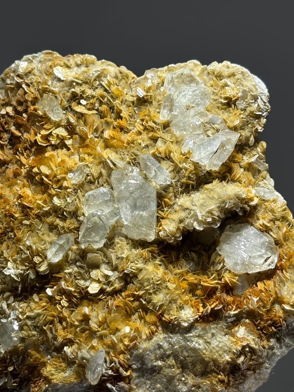 Golden mica plate with pale aquamarine crystals from Xuebaoding, Sichuan, China, close-up of the crystal faces