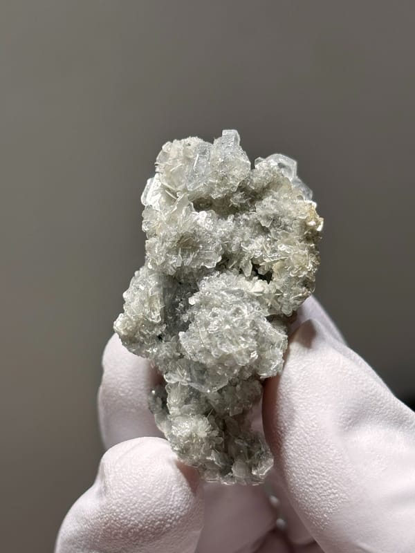 Small aquamarine crystals on pale mica cluster from Xuebaoding, Sichuan, China, second angle