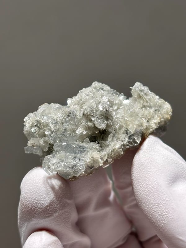 Small aquamarine crystals on pale mica cluster from Xuebaoding, Sichuan, China, reverse side