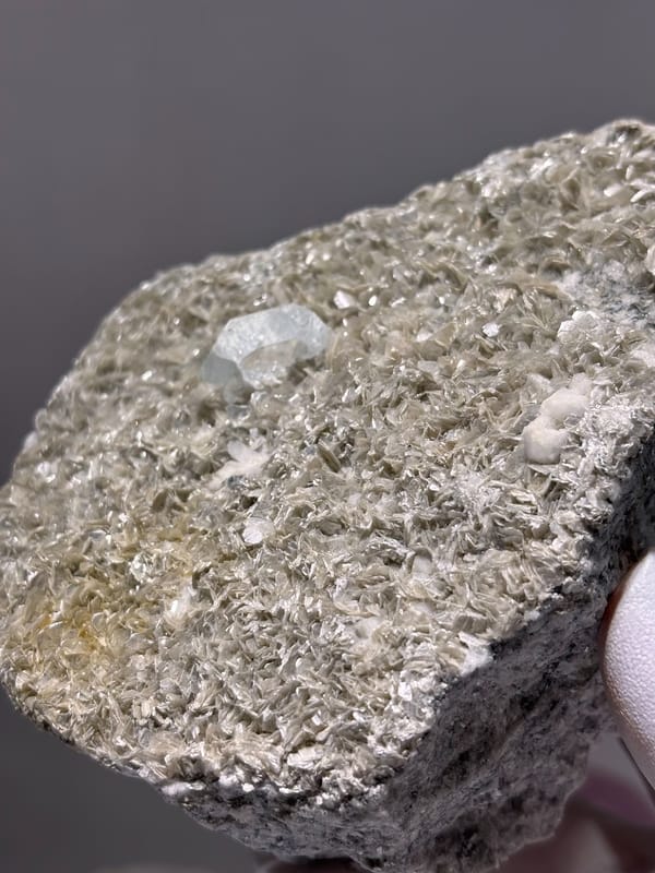 Silvery mica plate with pale aquamarine from Xuebaoding, Sichuan, China, close-up of the crystal faces