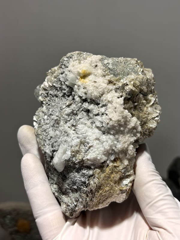 Free-standing mica block with pale blue aquamarine from Xuebaoding, Sichuan, China, close-up of the crystal faces