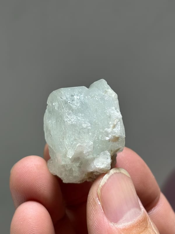 Glassy pale aquamarine with iridescent faces and scheelite from Xuebaoding, Sichuan, China, second angle