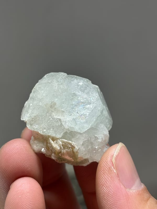 Glassy pale aquamarine with iridescent faces and scheelite from Xuebaoding, Sichuan, China, reverse side