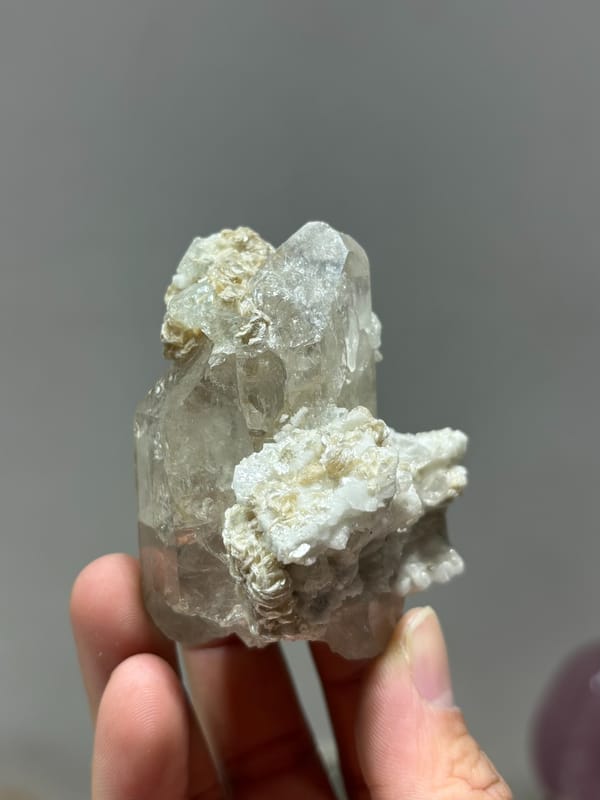 Quartz point over white feldspar with aquamarine and mica from Xuebaoding, Sichuan, China, reverse side