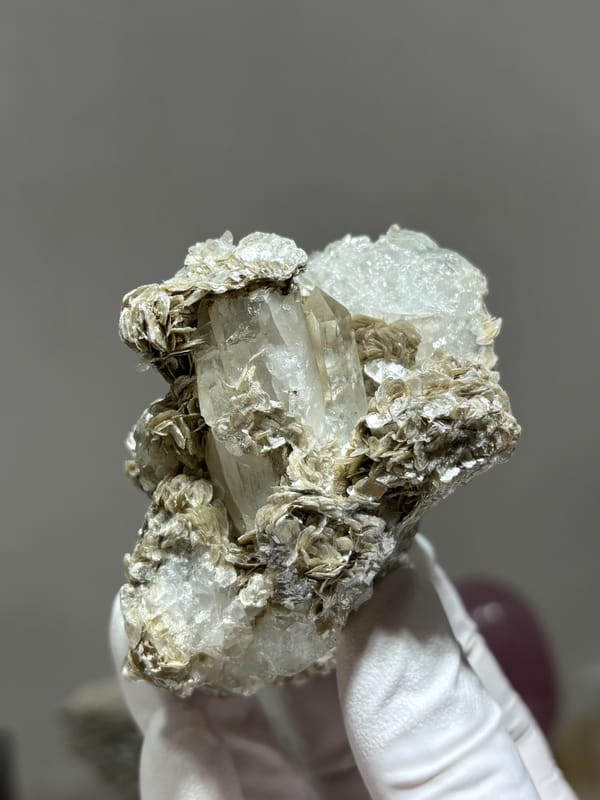 Clear quartz prism with pale aquamarine and mica from Xuebaoding, Sichuan, China, second angle