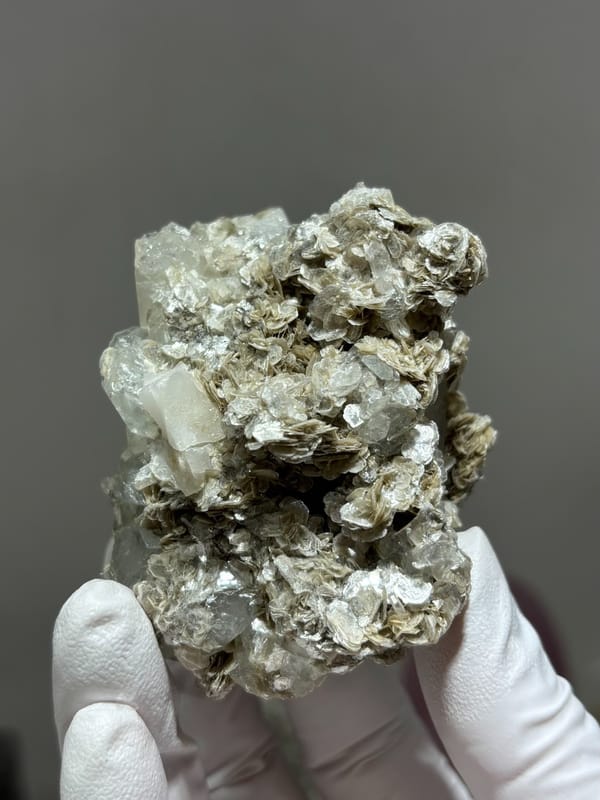 Clear quartz prism with pale aquamarine and mica from Xuebaoding, Sichuan, China, close-up of the crystal faces