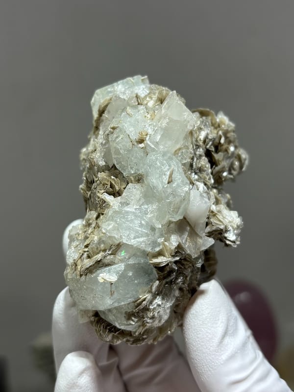 Clear quartz prism with pale aquamarine and mica from Xuebaoding, Sichuan, China, reverse side