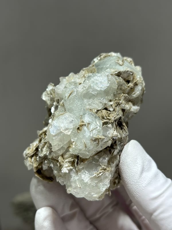 Clear quartz prism with pale aquamarine and mica from Xuebaoding, Sichuan, China, top view