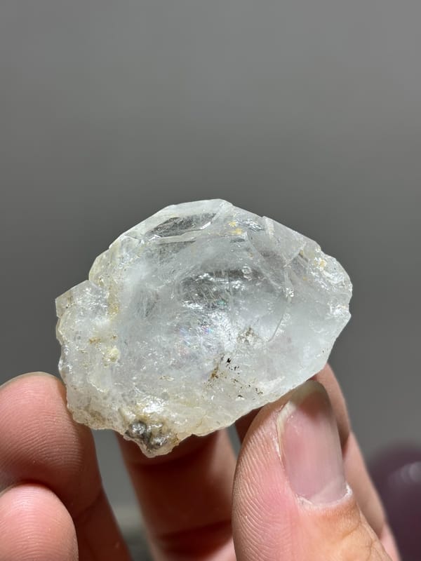Colourless transparent aquamarine tablet from Xuebaoding, Sichuan, China, held in hand