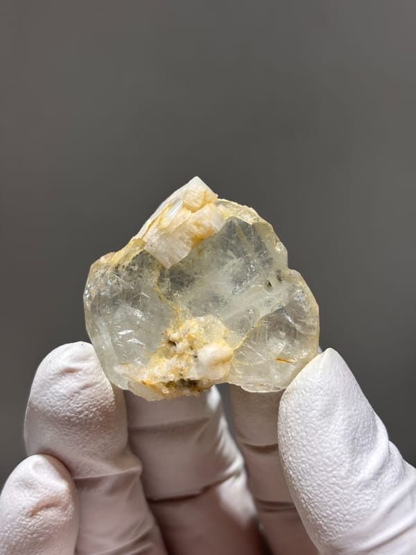 Clear aquamarine with golden feldspar patches from Xuebaoding, Sichuan, China, second angle