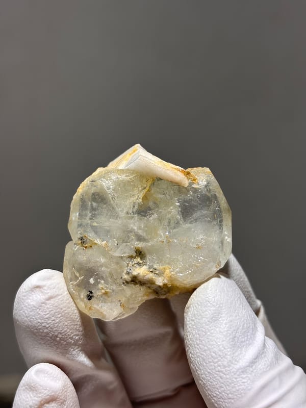 Clear aquamarine with golden feldspar patches from Xuebaoding, Sichuan, China, reverse side