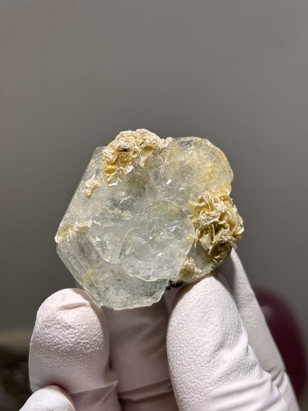 Clear aquamarine tablet with mica and jamesonite from Xuebaoding, Sichuan, China, second angle