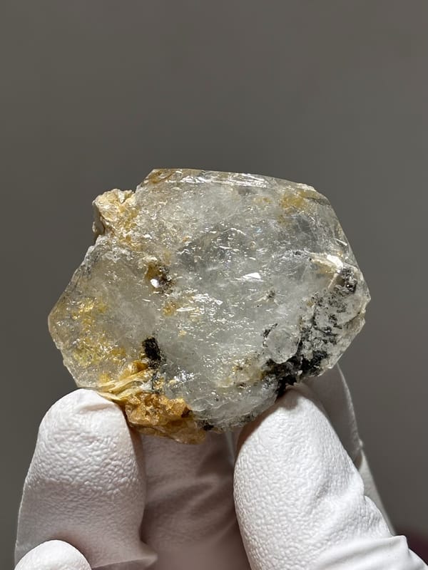 Clear aquamarine tablet with mica and jamesonite from Xuebaoding, Sichuan, China, reverse side