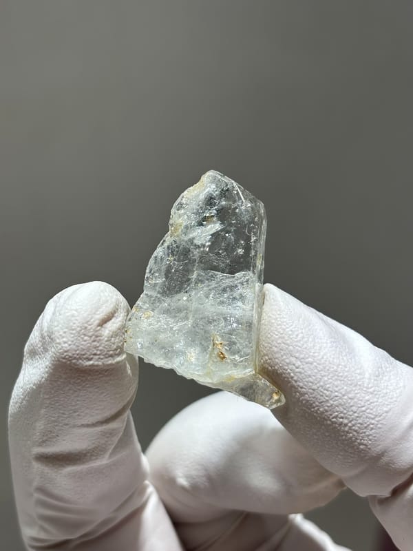 Tiny clear aquamarine crystal from Xuebaoding, Sichuan, China, close-up of the crystal faces