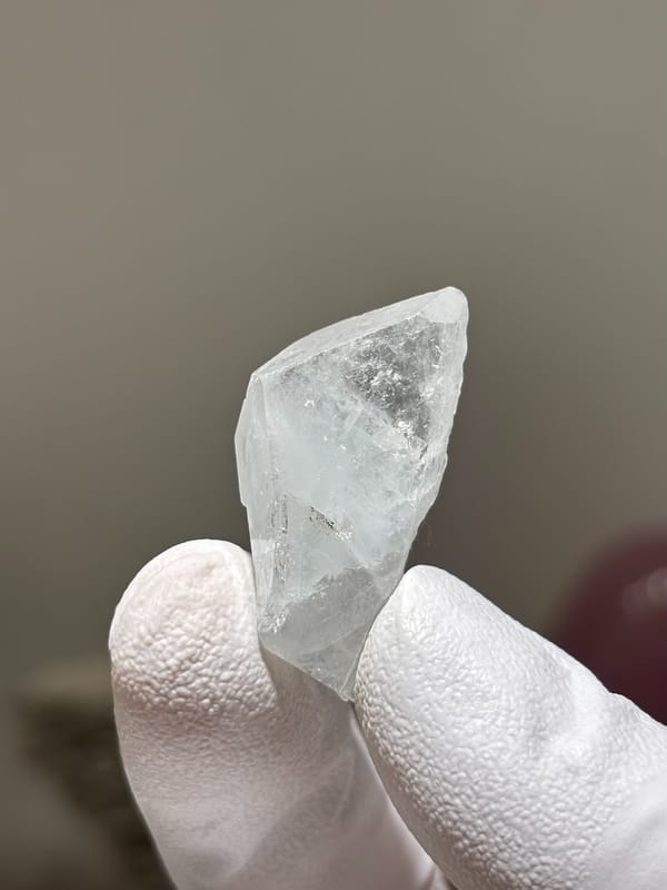 Tiny clear aquamarine tablet from Xuebaoding, Sichuan, China, close-up of the crystal faces