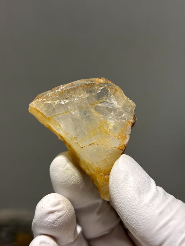 Clear aquamarine tablet with golden patch from Xuebaoding, Sichuan, China, second angle