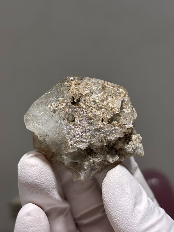 Etched pale aquamarine with clay-filled pocket from Xuebaoding, Sichuan, China, close-up of the crystal faces