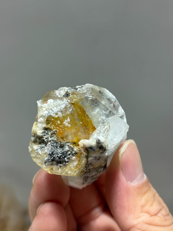 Yellow gel-flower aquamarine with mica and feldspar from Sichuan, China, close-up of the crystal faces