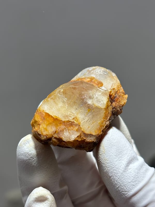 Gel-flower aquamarine with orange skin from Sichuan, China, close-up of the crystal faces