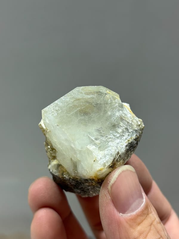 Glassy aquamarine group with mica and scheelite from Xuebaoding, Sichuan, China, close-up of the crystal faces