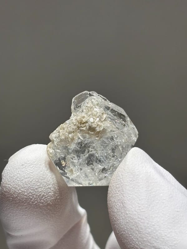 Tiny glassy aquamarine crystal from Xuebaoding, Sichuan, China, reverse side