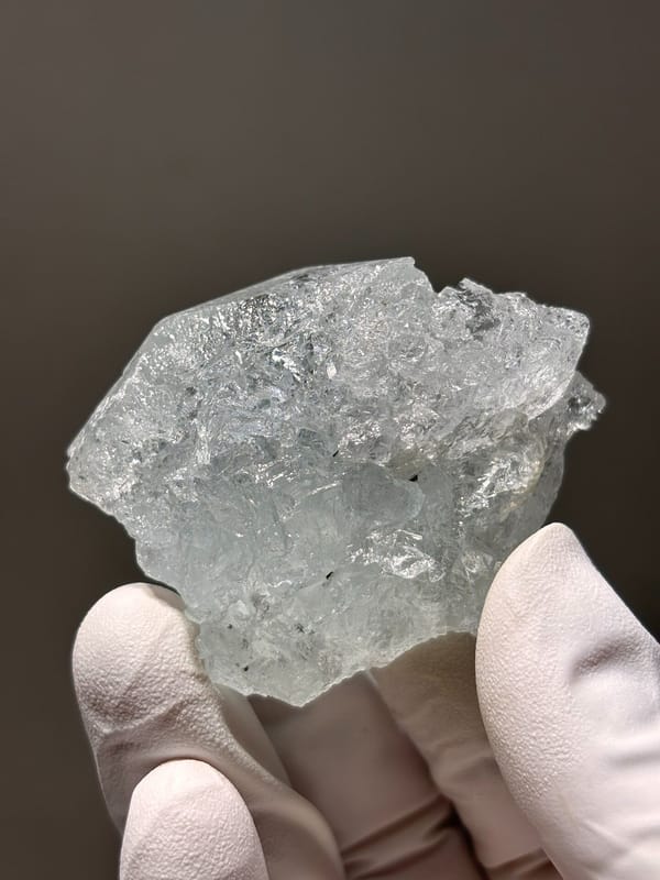 Glassy pale blue aquamarine block from Xuebaoding, Sichuan, China, close-up of the crystal faces