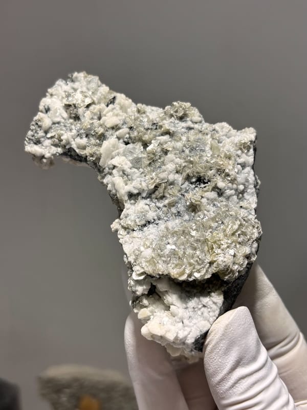 Grey matrix spire with aquamarine, mica and feldspar from Xuebaoding, Sichuan, China, second angle