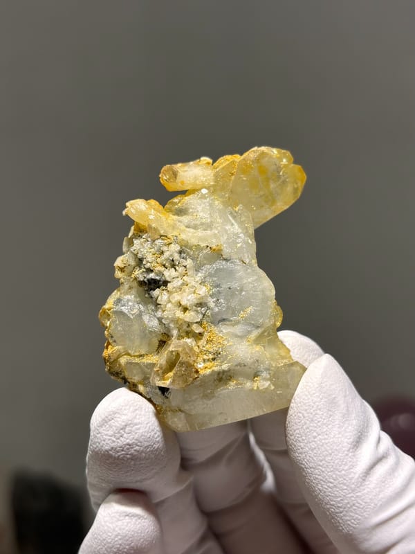 Multi-crystal aquamarine group with golden mica from Xuebaoding, Sichuan, China, close-up of the crystal faces