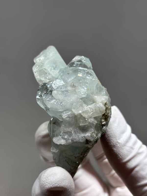 Multi-crystal aquamarine group with golden patch from Xuebaoding, Sichuan, China, close-up of the crystal faces
