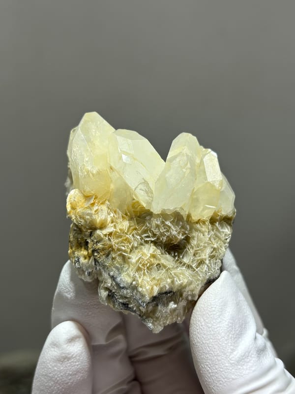 Near-colourless aquamarine cluster on golden mica from Xuebaoding, Sichuan, China, second angle