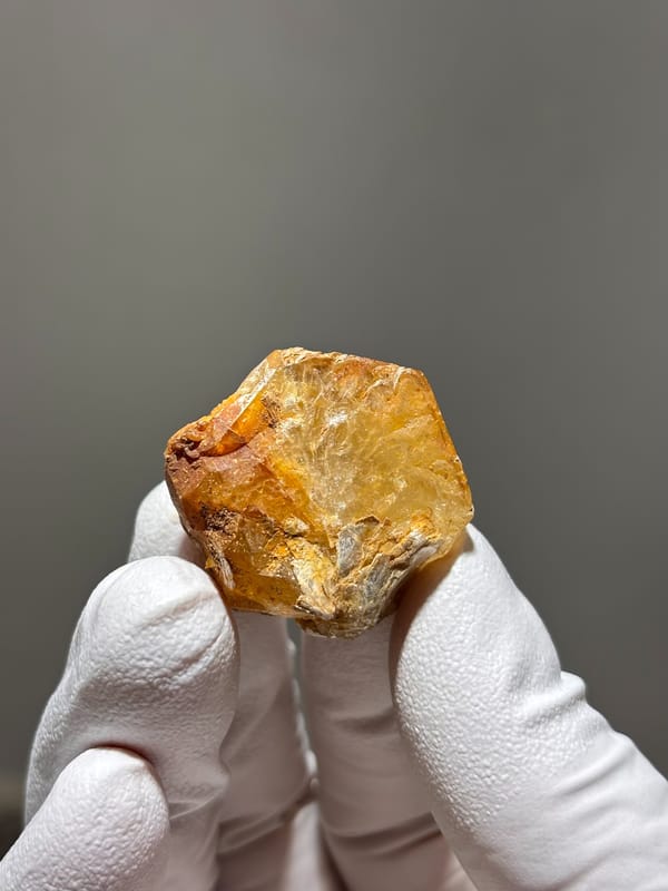 Orange-stained aquamarine tablet from Xuebaoding, Sichuan, China, second angle