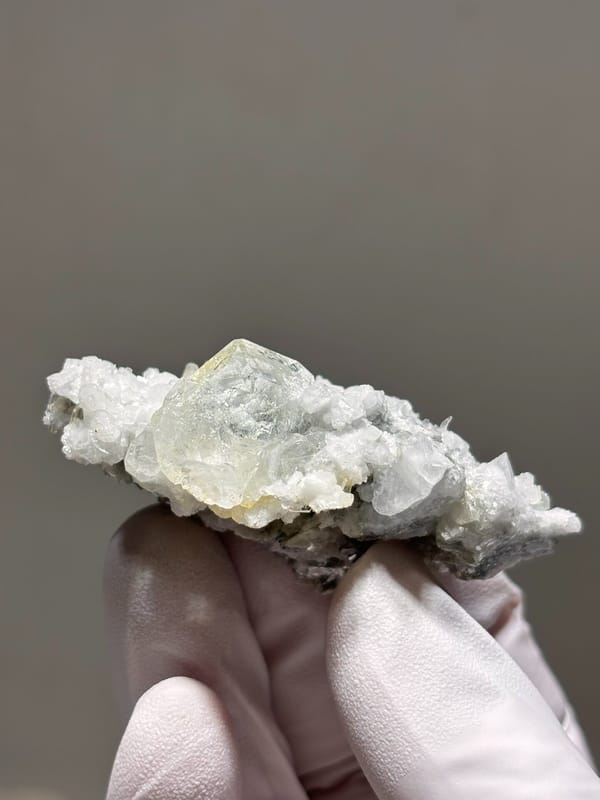 Pale aquamarine crystal on white feldspar from Xuebaoding, Sichuan, China, second angle