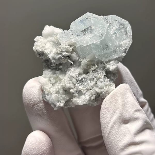 Pale blue Xuebaoding aquamarine on feldspar and mica matrix — alternate view