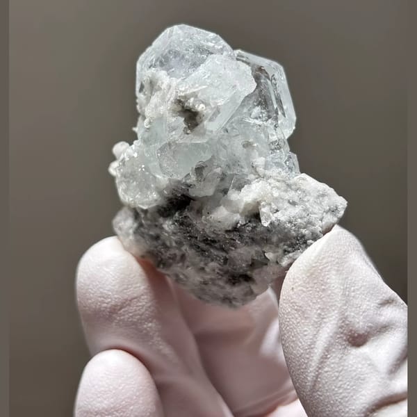 Pale blue Xuebaoding aquamarine on feldspar and mica matrix — alternate view
