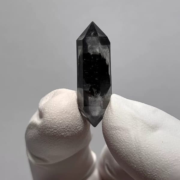 Double-terminated Yunnan quartz with a dark inclusion core — alternate view