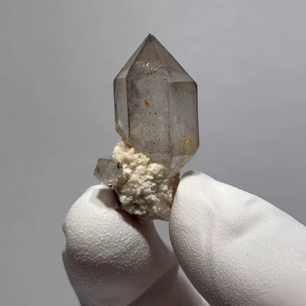 Yunnan quartz point with sketch-like inclusions and matrix base — complete view