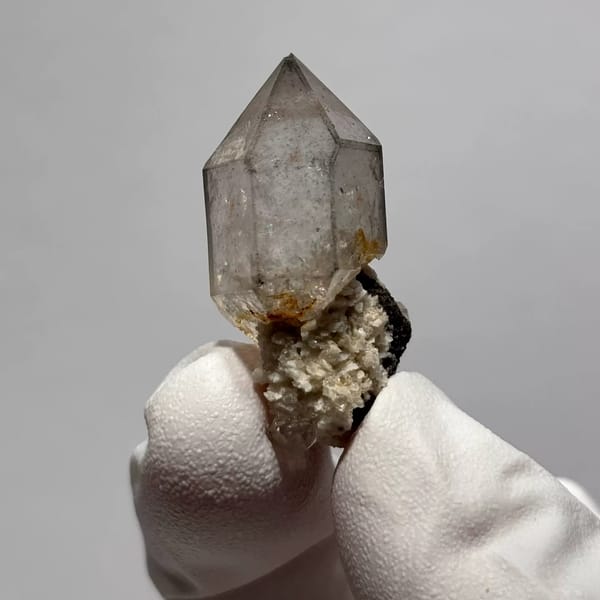 Yunnan quartz point with sketch-like inclusions and matrix base — alternate view