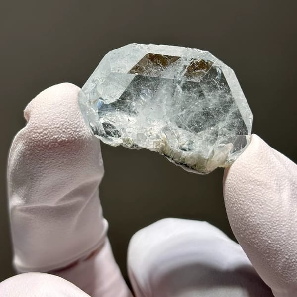 Clear pale blue Xuebaoding aquamarine crystal — complete view