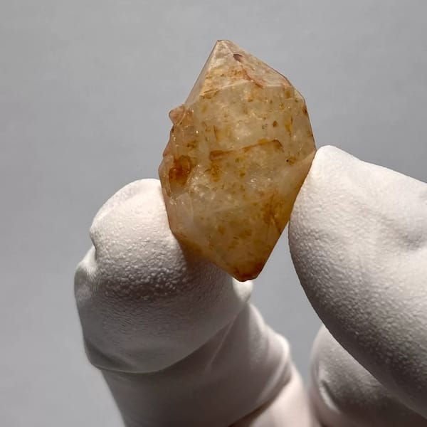 Yunnan quartz crystal with orange iron-oxide inclusions — alternate view