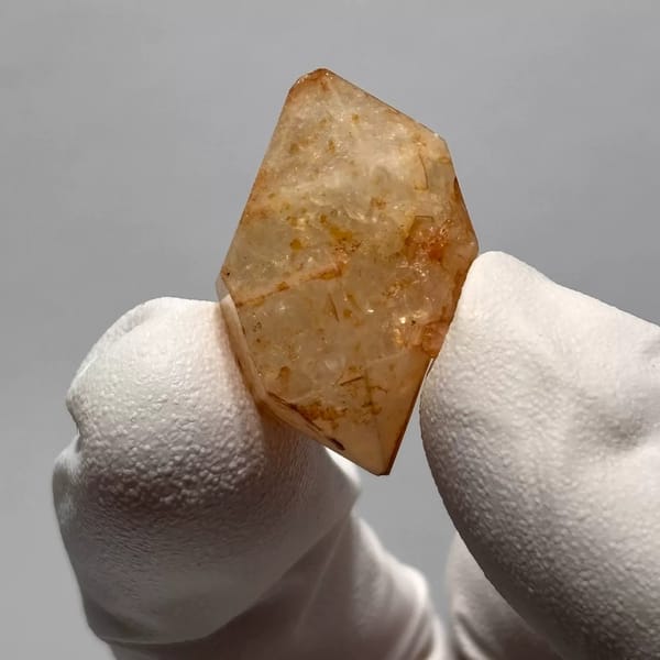 Yunnan quartz crystal with orange iron-oxide inclusions — detail view