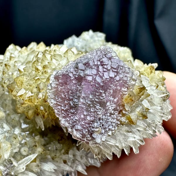 Purple-green fluorite octahedron on sparkling calcite matrix from Fujian, China, close-up of the crystal faces