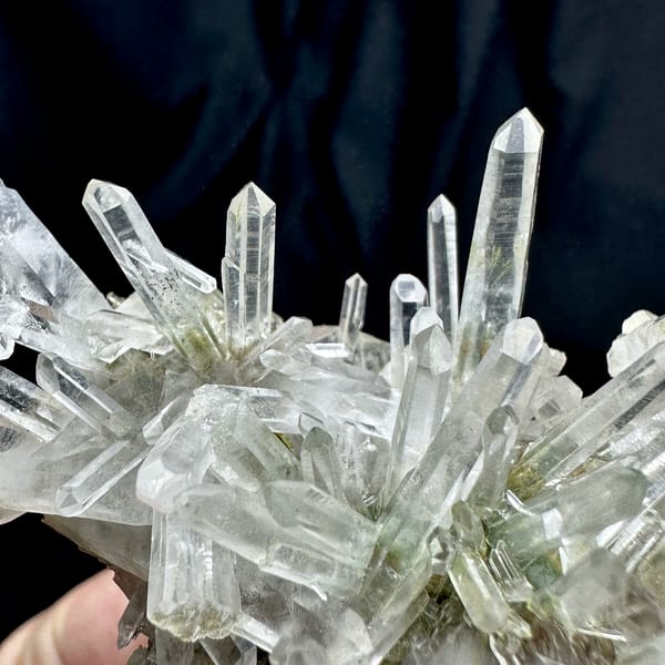 Radiating clear quartz needle cluster with green phantoms from Guangdong, China, top view