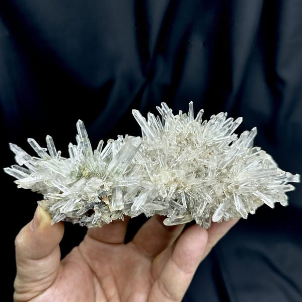 Radiating clear quartz needle cluster with green phantoms from Guangdong, China, detail of the matrix contact
