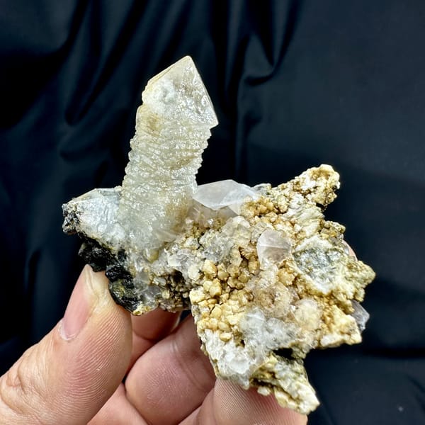Skeletal quartz point with green phantom on calcite and dolomite matrix from Inner Mongolia, close-up of the crystal faces