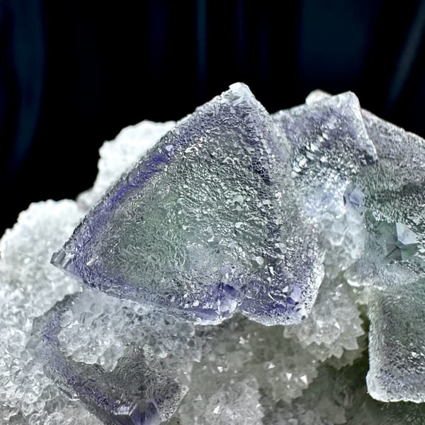 Row of purple and green zoned fluorite octahedra on quartz from Fujian, China, second angle