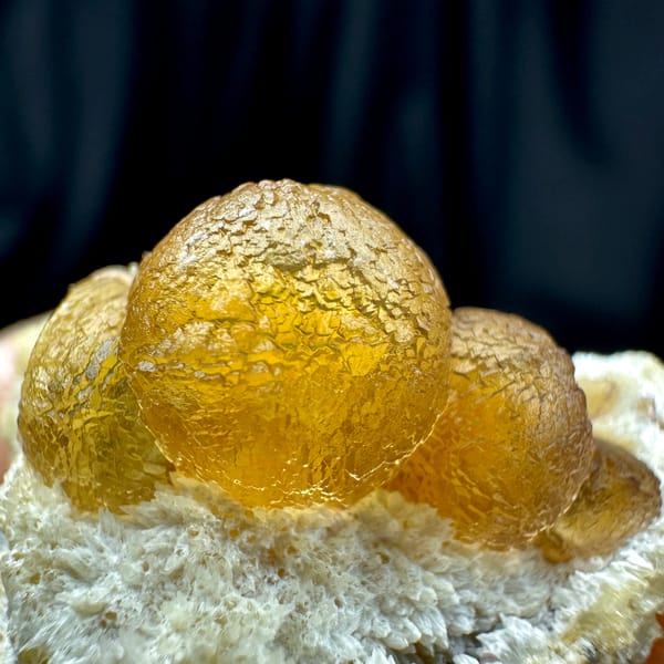 Two amber-yellow botryoidal fluorite balls on white quartz from Henan, China, second angle